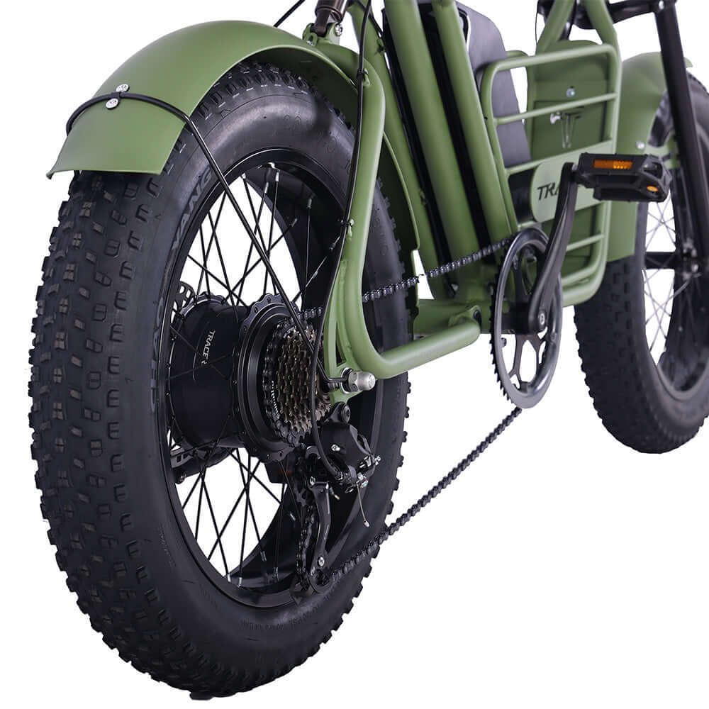 Close-up of Tracer Verge electric fat bike wheel and motor, showcasing robust fat black tires and sturdy green frame design.