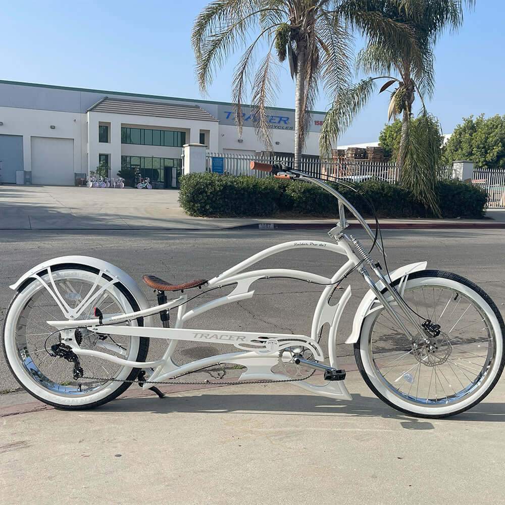 A white Raider Pro DS7 Stretch Chopper Cruiser Bike's side view, outdoors.