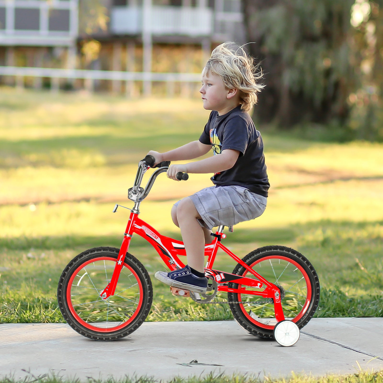 Kid riding bike store with training wheels